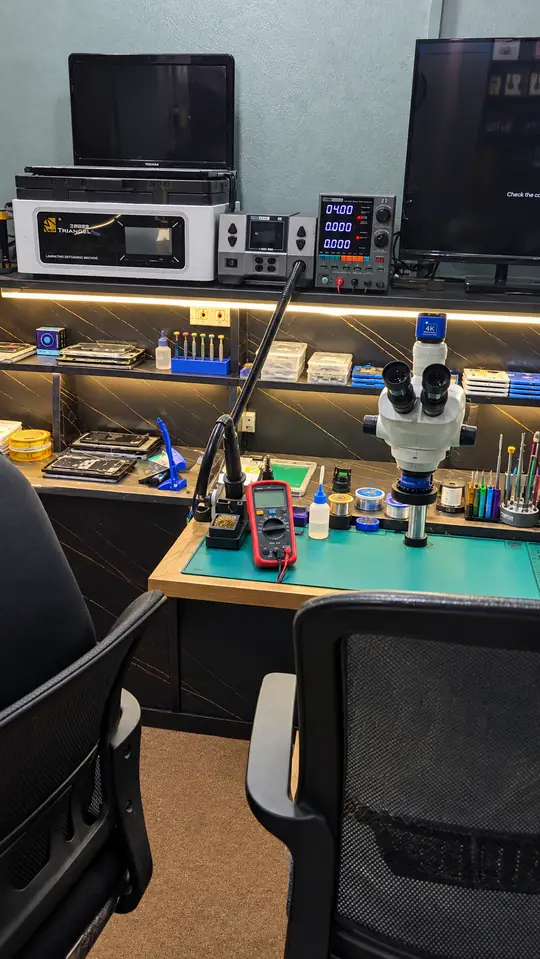 Repair bench with microscope at SK Mobiles Repairing Lab