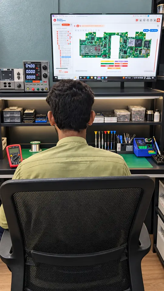 Reading the board schematic at SK Mobiles Repairing Lab