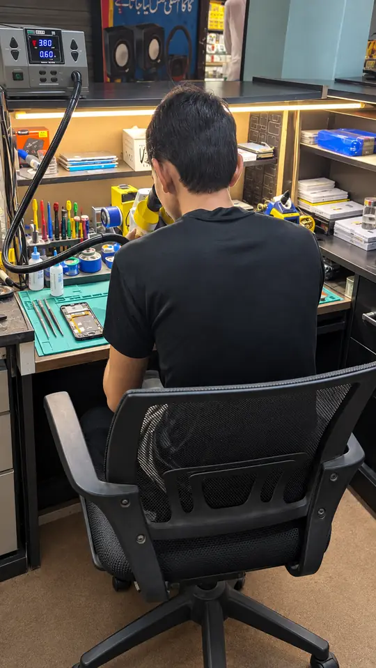 Board work at the bench at SK Mobiles Repairing Lab